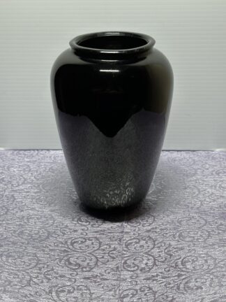 Urn style vase, appears black, but when light is inside it is deep red