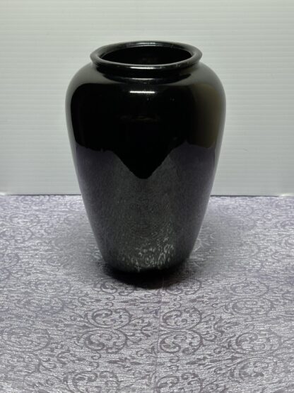Urn style vase, appears black, but when light is inside it is deep red